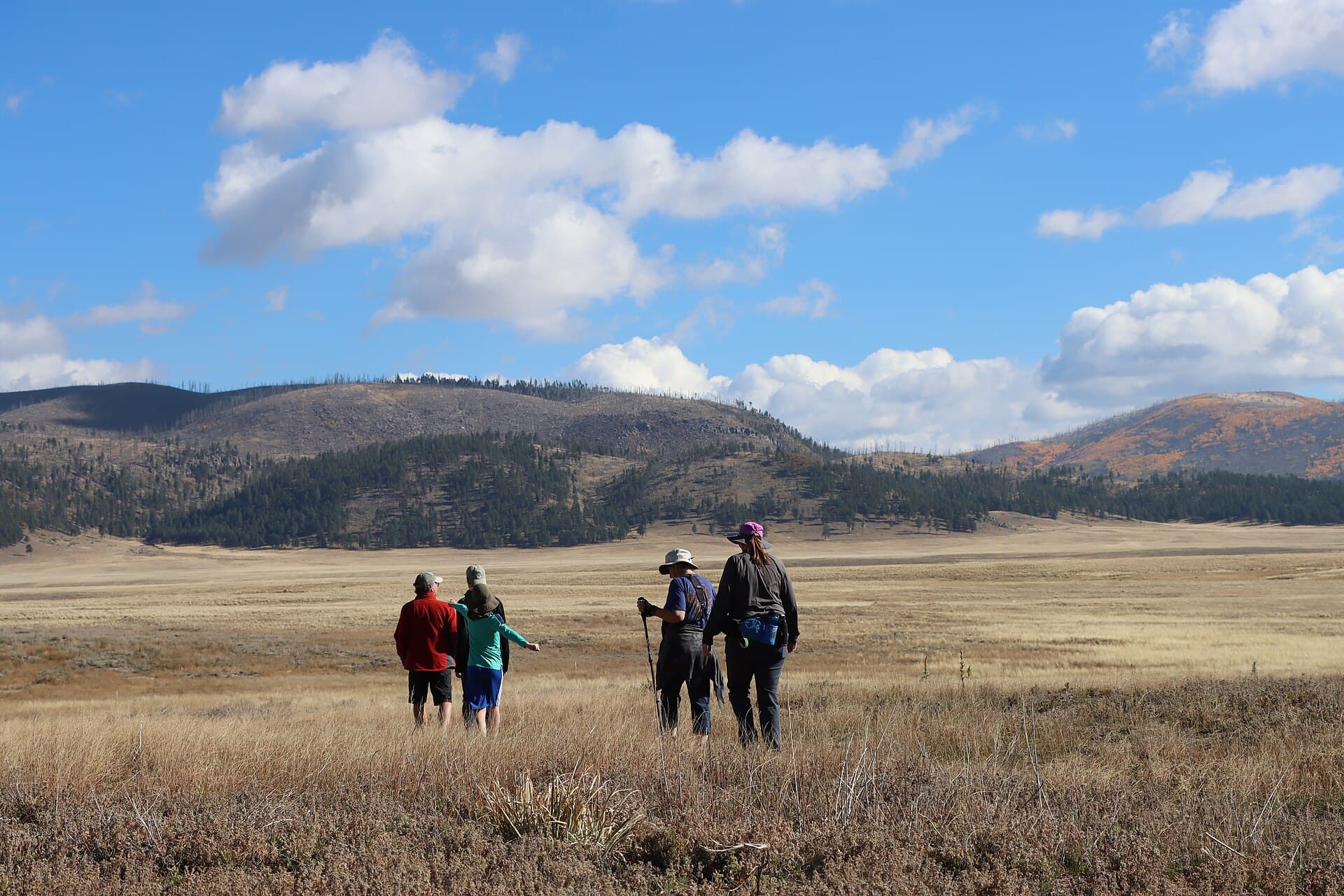 A family hiking together on the Valle Grande Exploration Trail
