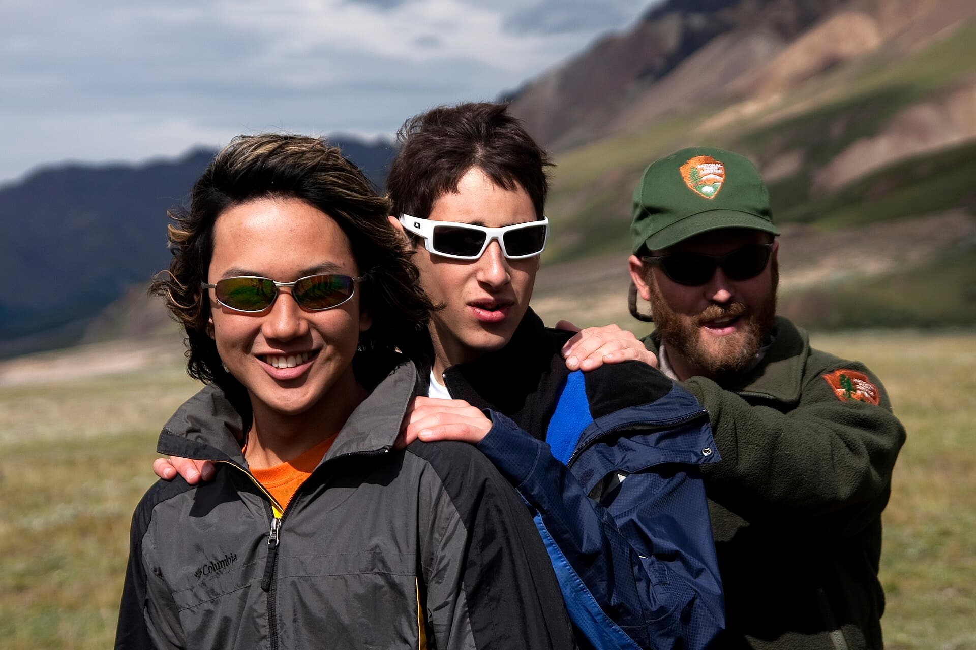 Hikers practicing a controlled river crossing in Denali